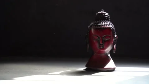 Buddha red Idol face with black background Stock Footage 136593112