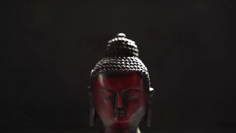 Buddha red Idol face close up with black background Stock Footage 136593999