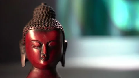 Buddha red Idol face meditating with dark background Stock Footage 136594599