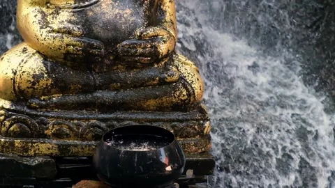 Buddha siting statue with water floating slowmotion Stock Footage 209811766