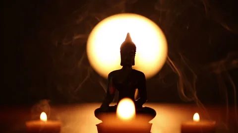 Buddha statue and three candles with incense smoke Stock Footage 45955292