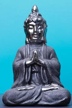 Buddha statue on blue background Stock Photos