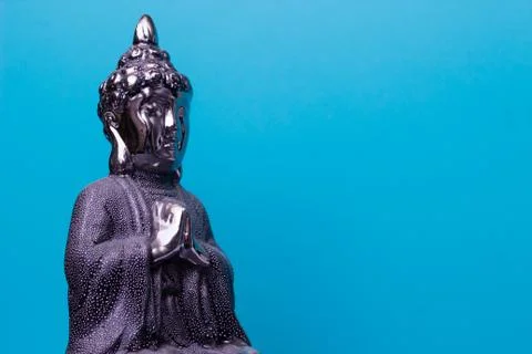 Buddha statue on a blue background Stock Photos