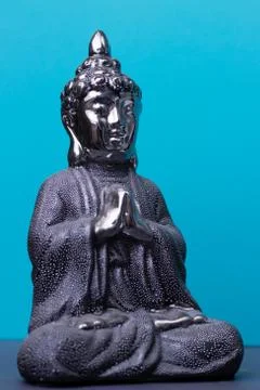 Buddha statue on a blue background Stock Photos