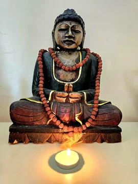 Buddha statue with a candle Stock Photos