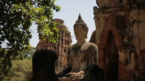 A Buddha statue in front of old ruins in Ayutthaya Historical Park, Thailand Stock Footage 65712243