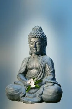 Buddha statue holds apple tree flower in the hands. Religious theme template. Stock Photos