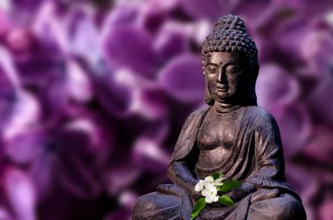 Buddha statue holds apple tree flower in the hands. Religious theme template. Stock Photos