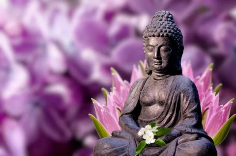 Buddha statue holds apple tree flower in the hands. Religious theme template. Stock Photos