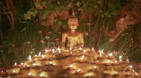Buddha statue with light the candles under Bodhi tree,  Seamless looping . Stock Footage 65325562