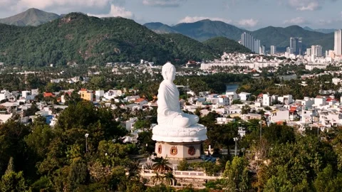 Buddha statue at long son pagoda over nha trang city in vietnam with, aeria.. Vídeo Stock 335018707