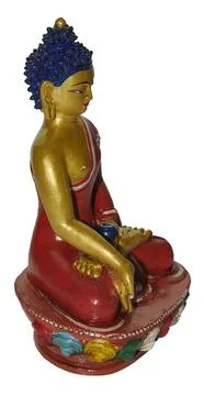 Buddha statue meditating in red robe with golden skin Stock-Fotos