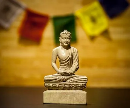 Buddha statue with prayer flag Stock Photos