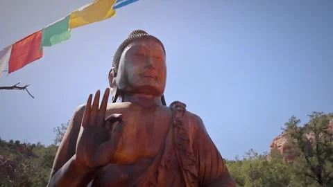 Buddha Statue Prayer Flags and Red Rock Landscape Sedona Arizona Stock Footage 336383952