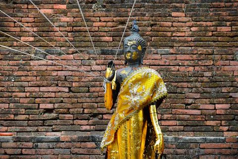 Buddha statue with sacred threads Stock Photos