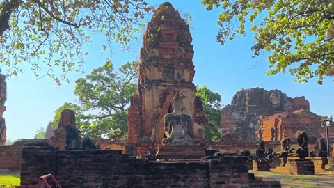 Buddha statue sits within the crumbling red brick ruins of ancient temple. Stock-Footage 310351791