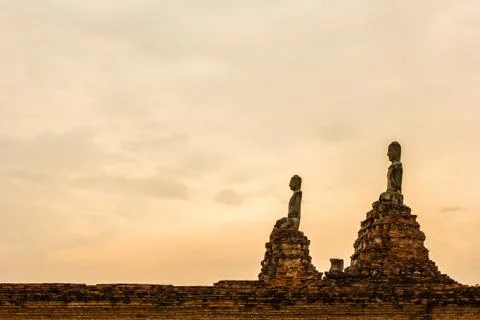 Buddha statue on sunset sky background Stock Photos