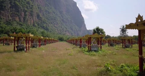 Buddha statues , valley of a thousand buddhas in a field between the mountains,  Stock Footage 295215549