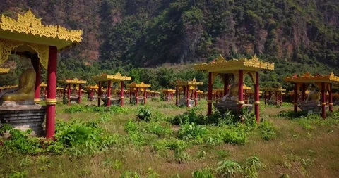 Buddha statues , valley of a thousand buddhas in a field between the mountains,  Stock Footage 295965349