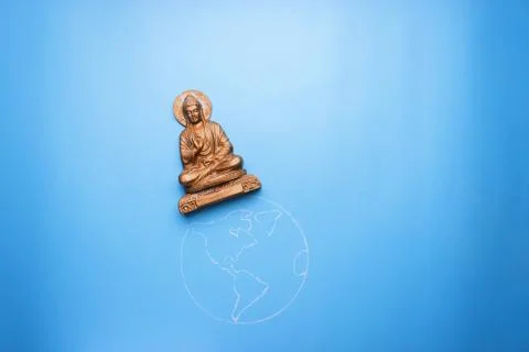 Buddha statuette on the earth Stock Photos