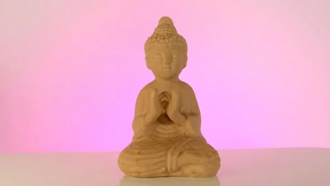 Buddha statuette on a pink background. Stock Footage 154734351