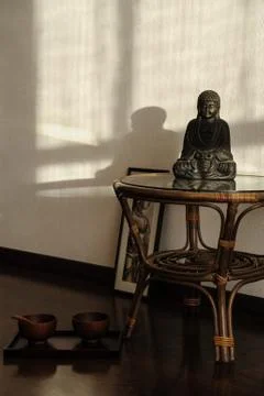 Buddha statuette on the table Stock Photos