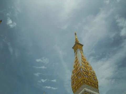 Buddhist chedi piercing sky in time-lapse of cloudscape Stock Footage 83047424