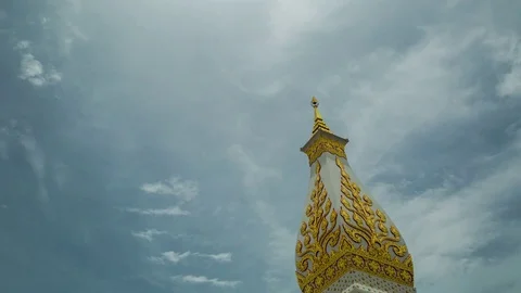 Buddhist chedi piercing sky in time-lapse of cloudscape Stock Footage 84856714