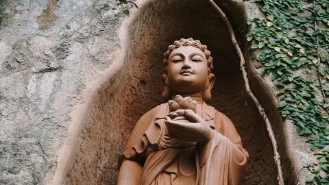 Buddhist Deity Statue Standing In Stone Hole Stock Footage 116470074