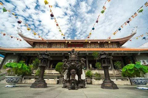 Buddhist deity statues on a square in front of beautiful colorful Buddhist .. Stock Photos