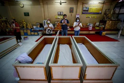 Buddhist devotees lie inside coffins for good karma, Bangkok, Thailand - 13 Feb  Stock Photos
