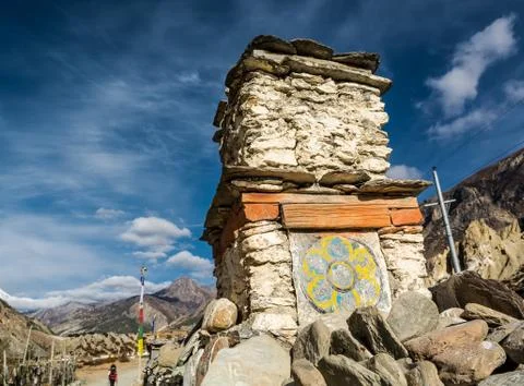 Buddhist drawing on a stone structure along trekking path. Stock Photos