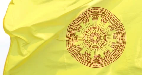 Buddhist flag with Dharmachakra symbol waving in the wind representing faith Video stock 335740197