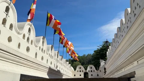 Buddhist flag fluttering in the wind, Buddhist Tooth Temple, Kandy, Sri Lanka Stock Footage 329214902