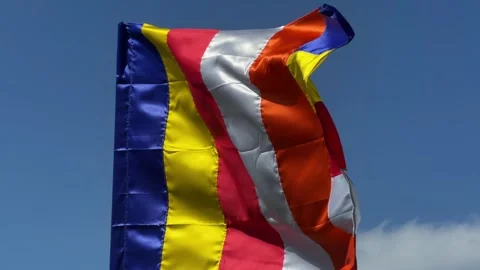 Buddhist flag with vertical colored stripes moves steadily in the breeze against 動画素材 329304485