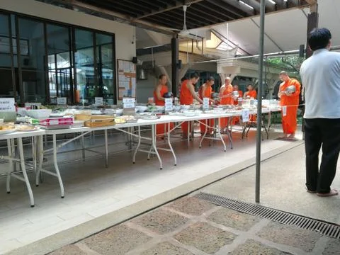 Buddhist give the offering dedicated essentials and food to the monks at Thai Stock Photos
