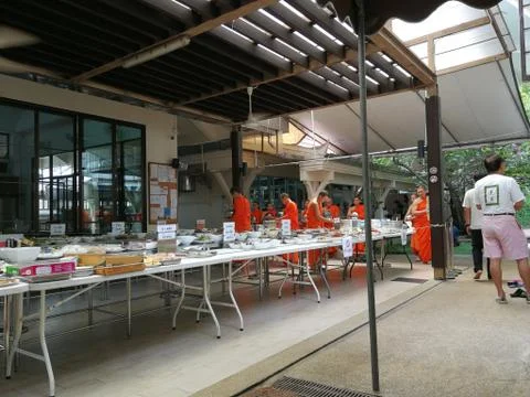 Buddhist give the offering dedicated essentials and food to the monks at Thai Stock Photos