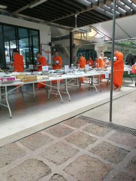 Buddhist give the offering dedicated essentials and food to the monks at Thai Stock Photos