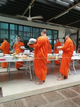 Buddhist give the offering dedicated essentials and food to the monks at Thai Stock Photos