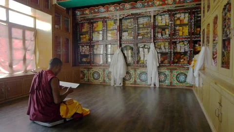 A Buddhist Lama meditates in the gompa Stock Footage 130362262