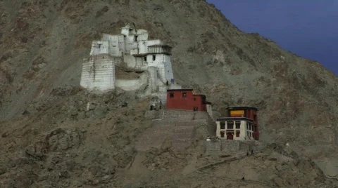 Buddhist Monastery with people walking up steps Stock Footage 235198