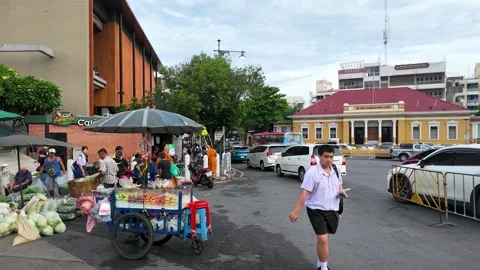 Buddhist Monk and Fruit Vendor on Busy Bangkok Street Stock Footage 339514076