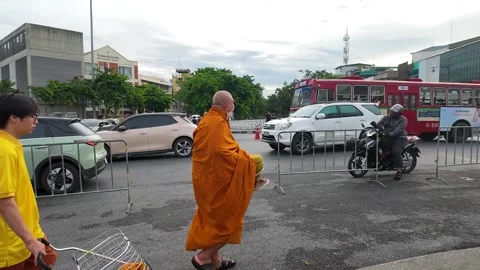 Buddhist Monk and Student Walking Near Busy Bangkok Street Traffic Stock Footage 340191960