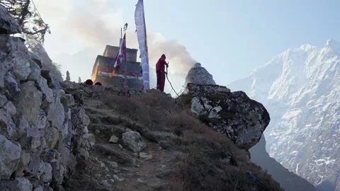 Buddhist monk burn a fire outside temple, dense smoking around snowy mountains Stock Footage 167418613