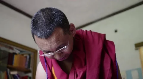 Buddhist Monk with glasses talking close up Stock Footage 60206823