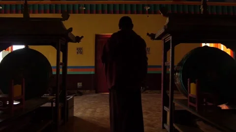 Buddhist monk goes outside Stock Footage 130223767