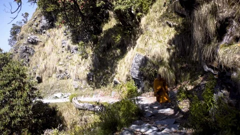 Buddhist monk on mountain path Stock Footage 97858075