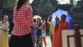 Buddhist monk in orange clothes with blue umbrella in Angkor Thom temple complex HD Footage
