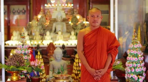 Buddhist monk with orange robe pray in temple Stock Footage 12178141