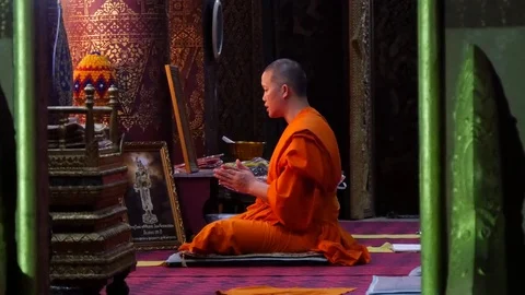Buddhist monk with orange robe pray in temple Luang Prabang Laos Stock Footage 74684292